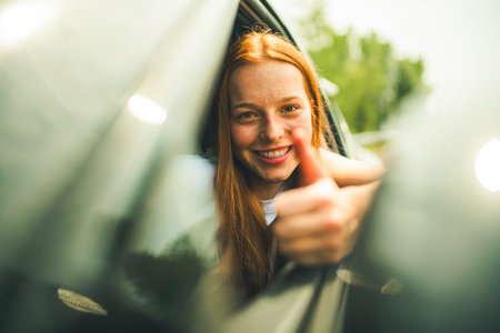 Beautiful young girl driver with with her white car