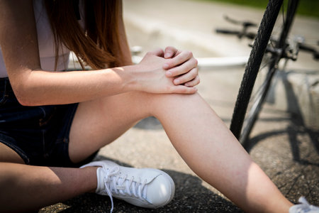 Outdoor, cycling and woman portrait injuryの写真素材