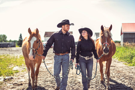 couple boy and girl, stands next to her horse in summer season