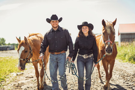 couple stands next to her horse in summer seasonの写真素材