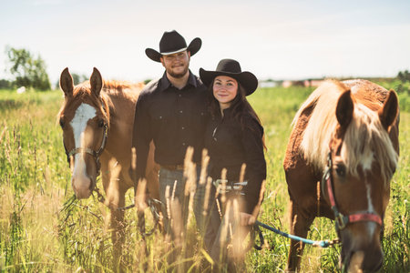couple boy and girl, stands next to her horse in summer season