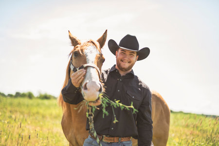 cowboy, stands next to her horse in summer season