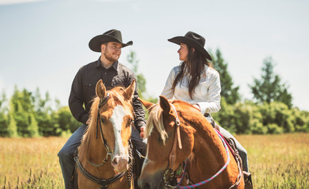 couple boy and girl, stands next to her horse in summer seasonの写真素材