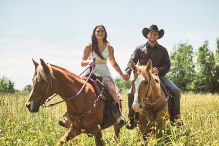 couple, stands next to her horse in summer seasonの写真素材