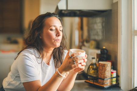 happy woman drinking coffee on the kitchen in the morning.の写真素材