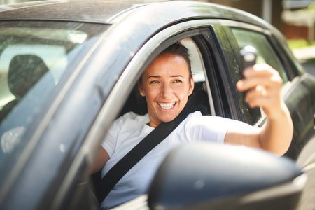 woman at car window drive a new car