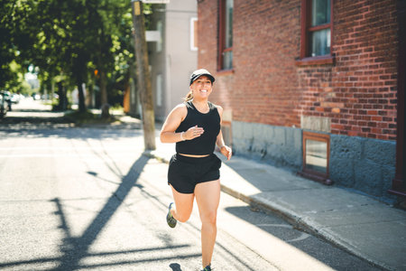 woman running outdoors, middle aged woman in sportswear.の写真素材