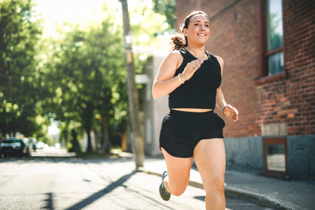 woman running outdoors, middle aged woman in sportswear.の写真素材