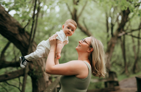 Happy family on a summer meadow. little girl child baby daughter with motherの写真素材