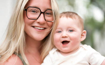Happy family on a summer meadow. little girl child baby daughter with motherの写真素材