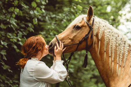 A woman is wearing a cowboy hat while riding a horse in an open field