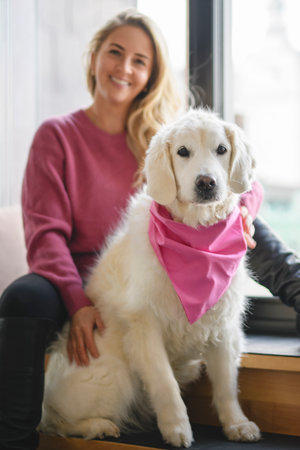 Teen Girl with her golden retriever dog at home