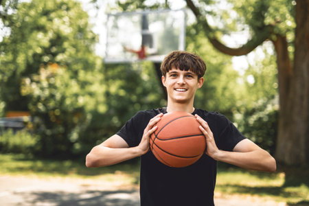 Handsome male playing basketball outdoor