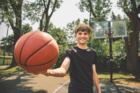 Handsome male playing basketball outdoor