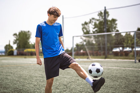 motivation soccer player with a football in a sport uniform