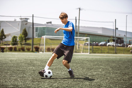 motivation soccer player with a football in a sport uniformの写真素材