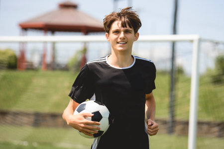 motivation soccer player with a football in a sport uniformの写真素材
