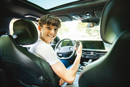 teen driver on car on summer day