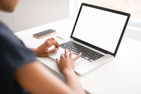 White background computer view. analyst woman using laptop computer in office.の写真素材