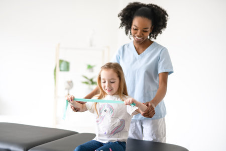 Physiotherapist working with child girl patient in a rehab clinicの写真素材