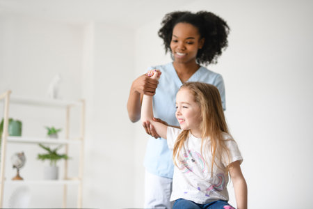 Physiotherapist working with child girl patient in a rehab clinicの写真素材