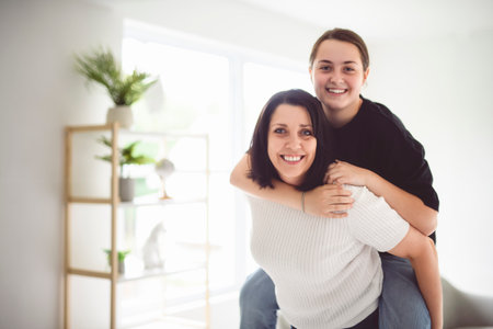 mother with teen girl, having great time at homeの写真素材