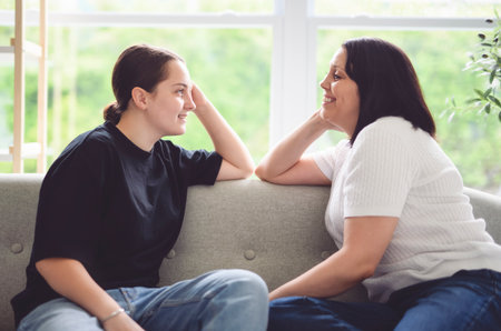 mother comforting depressed sad teen girl, talk with daughter, care, speaking, giving sympathyの写真素材