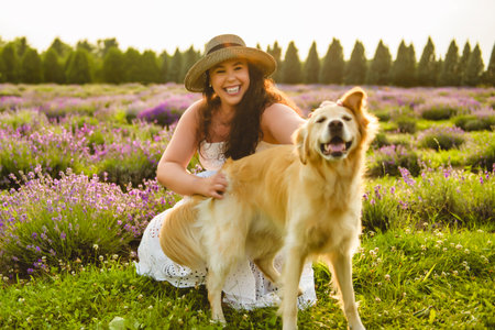 woman with golden retriever on a lavender fieldの写真素材