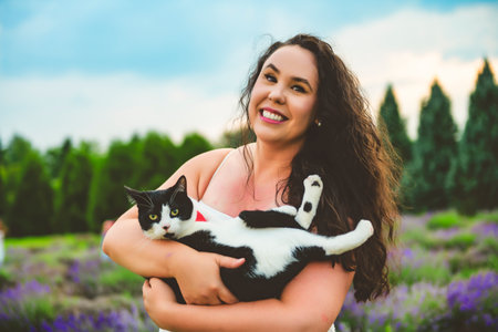 woman with cat friend on a lavender fieldの写真素材
