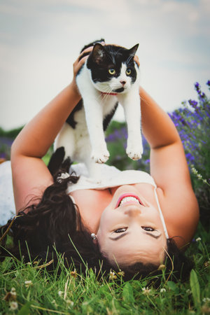 woman with cat friend on a lavender fieldの写真素材