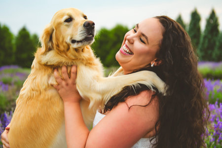 woman with golden retriever on a lavender fieldの写真素材
