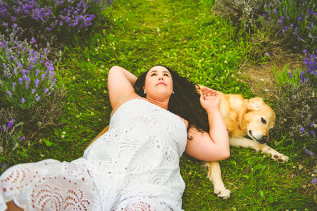 woman with golden retriever on a lavender field