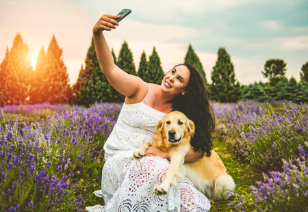 woman with golden retriever on a lavender field