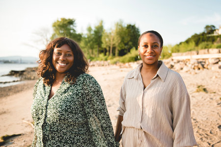 Cheerful sister on a beautiful seascapeの写真素材