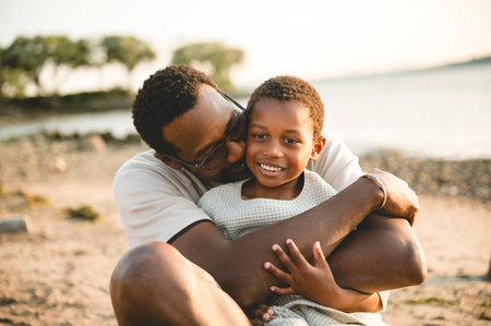 Cheerful father and son against beautiful seascapeの写真素材