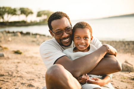 Cheerful father and son against beautiful seascapeの写真素材