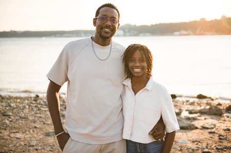 Cheerful father and her daughter on beautiful seascape