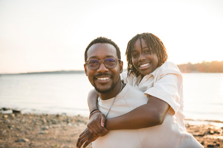Cheerful father and his daughter on beautiful seascapeの写真素材