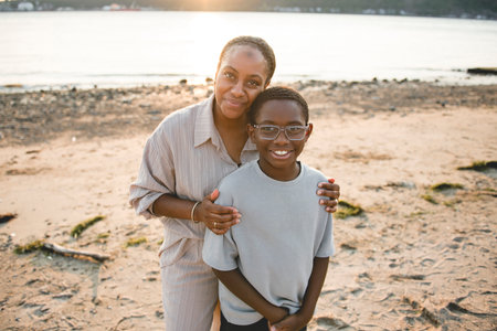 Cheerful mother and her son on beautiful seascapeの写真素材
