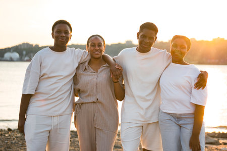 Portrait of big black family on beach at the sunsetの写真素材