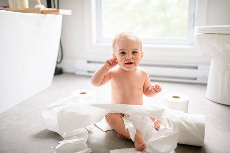 Toddler ripping up toilet paper