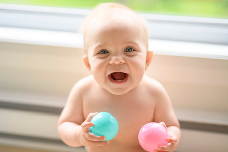 8 months old baby playing with balls.の写真素材