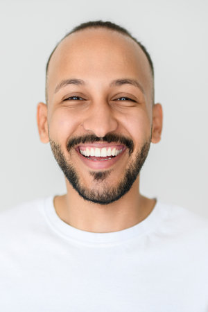 young arab man against white studio wall