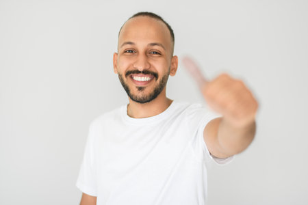 young arab man against white studio wall