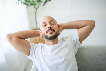 young arab man relaxing on sofa at home