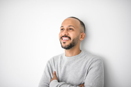 young islamic arab man against white studio wall