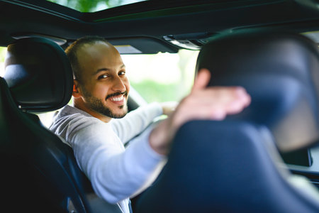 young arab man with his new car