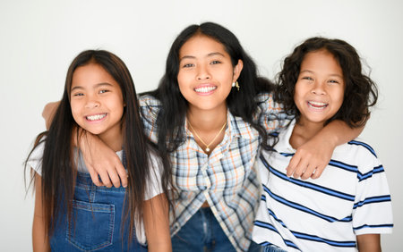 teen girl with 9 years thailand twin on studio white background with teen sister