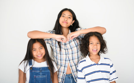 teen girl with 9 years thailand twin on studio white backgroundの写真素材