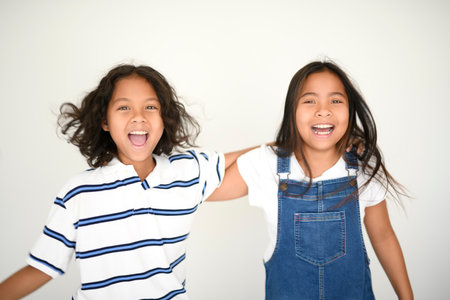two 9 years thailand twin on studio shot isolated white background